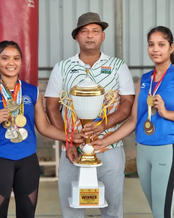 I am incredibly proud of my female boxers. Here I am with two of my students, celebrating their victory with a championship trophy and their hard earned medals from a major tournament.