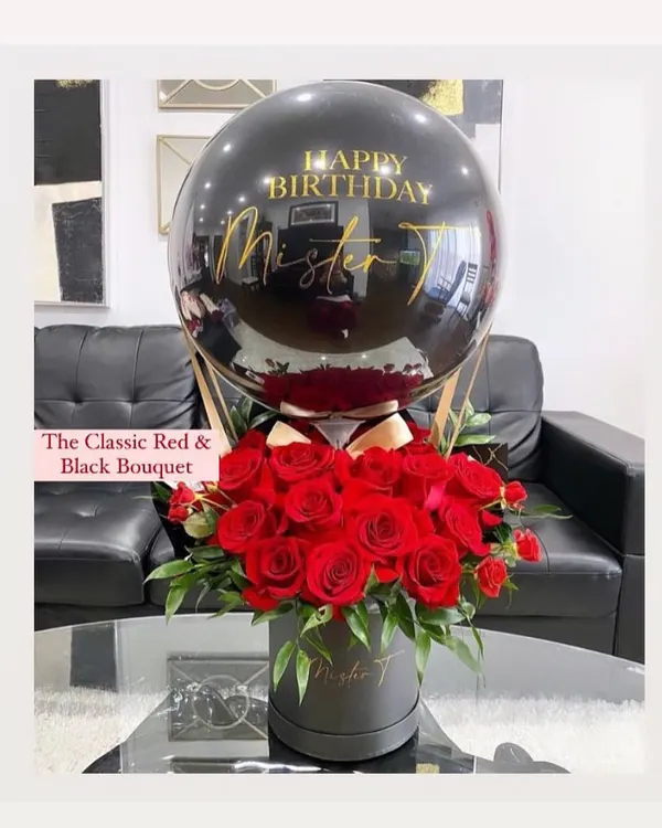 Our classic red and black hot air balloon hamper is pure elegance. It features a personalized message on a sleek black balloon, floating above a box of fresh, deep red roses, making it a perfect gift for a loved one.