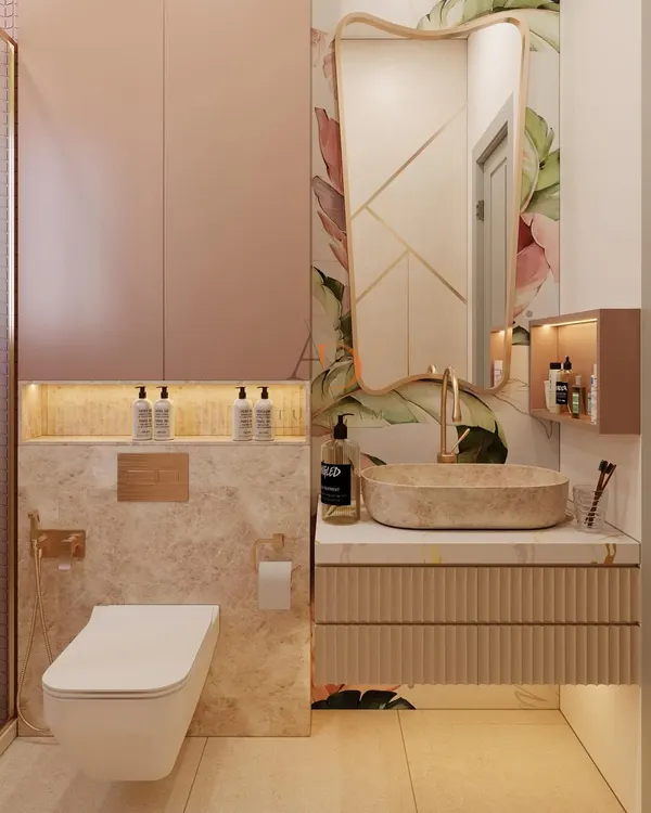This bathroom vanity is a statement in modern luxury, featuring a ribbed floating cabinet, a natural stone vessel sink, and rose gold fixtures. The design is complemented by a floral accent wall and a backlit niche for a spa-like feel.