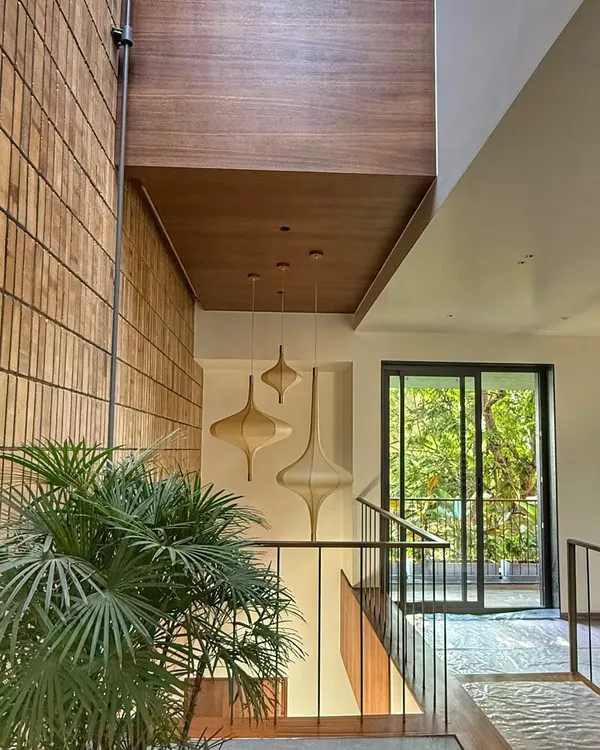 A feature wall of exposed brick in our project, "The Brick Affair". The natural texture and color variation of the bricks add immense warmth and character to this staircase area.