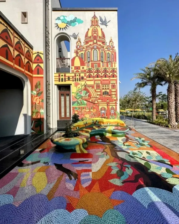 We believe art should be an experience that consumes you, not just something you hang on a wall. For this residential project in Rajkot, we turned an entire entrance volume into a vibrant labyrinth, starting with a custom mosaic floor that flows into a functional art bench and climbs up the facade in a hand-painted mural. This is what we mean when we say we turn spaces into stories.