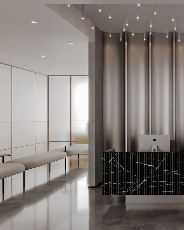 This eye clinic project combines timeless aesthetics with optimal functionality. The reception features a bold, fluted black marble desk set against a metallic curtain, while the waiting area beyond uses frosted glass and soft lighting for a calming effect.