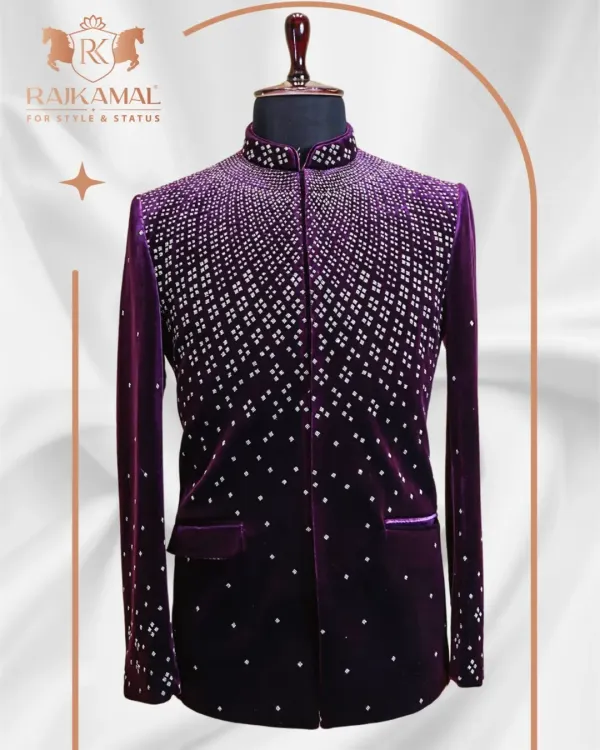 A stunning Jodhpuri suit in rich purple velvet. The jacket features a cascading pattern of silver embellishments, creating a dazzling, starry-night effect that is perfect for a grand reception.