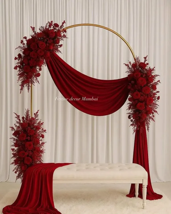 For a bold and romantic statement, this modern circular arch with deep red roses and velvet drapes is perfect for engagements or receptions. It’s a design that guarantees stunning photographs.