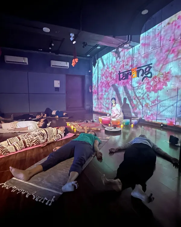 This is what our immersive sound bath sessions look like. We create a complete sensory experience with soothing sounds, low lighting, and calming nature visuals projected on the wall, helping you fully disconnect and find your inner *shaanti*.
