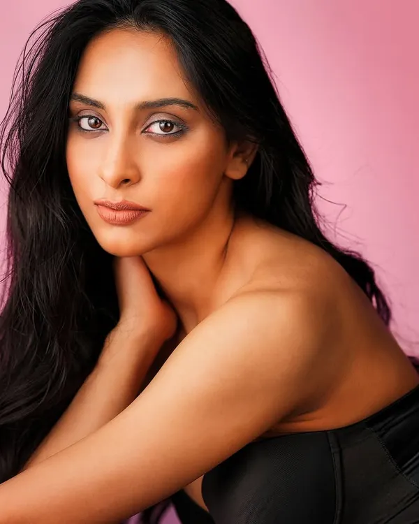 A classic beauty portrait. I used a soft, flattering light setup against a simple pink background to create a clean, elegant look that focuses entirely on the subject's expressive features.