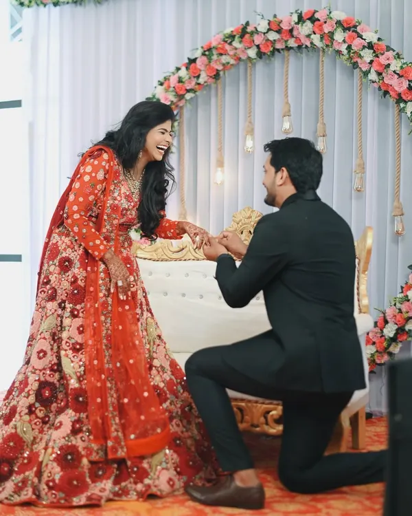 The pure, unscripted joy of a proposal. Nikita's laughter as Dhananjay gets down on one knee is a perfect example of the candid, emotional moments I aim to capture during an engagement ceremony.