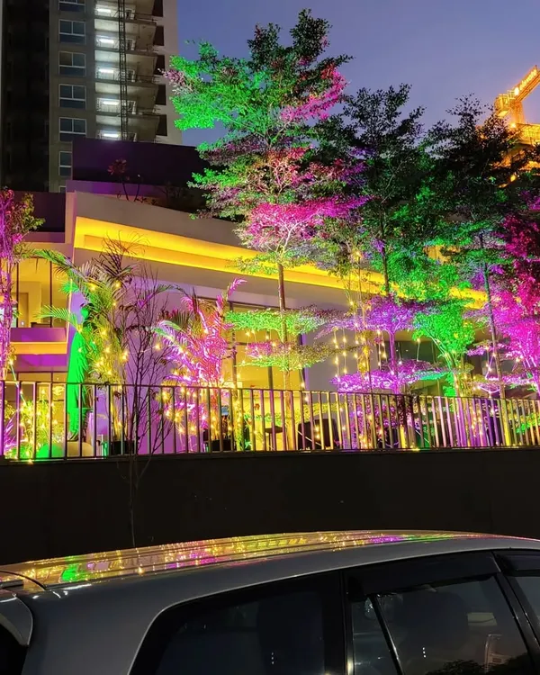 We use a combination of colorful uplighting and warm fairy lights to create a magical atmosphere for evening garden parties, completely transforming the look of the venue.