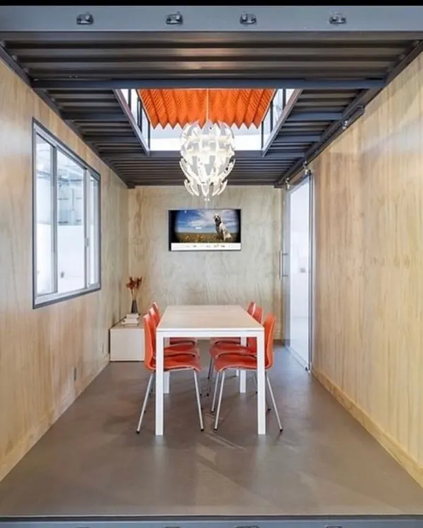A look inside a modern, portable office we designed. This space features clean lines, natural wood paneling, and ample light from a skylight, creating a productive and inspiring work environment that can be deployed anywhere.