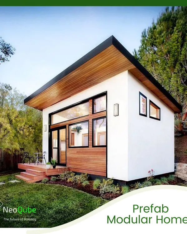 A prime example of our prefab modular homes, featuring a mix of white stucco and natural wood cladding. This design emphasizes a strong connection to the outdoors with its large glass facade and elevated deck.