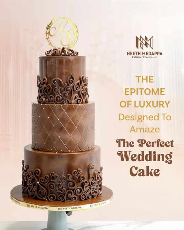 The epitome of luxury, this four-tiered all-chocolate wedding cake is designed to amaze. It features different textures on each tier, from a quilted pattern to intricate heart-shaped scrollwork, all topped with a custom gold monogram.