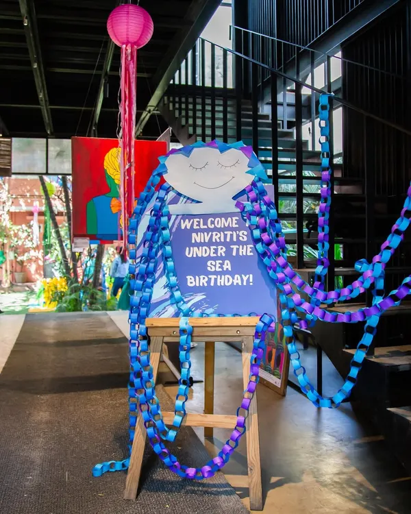 The adventure begins here! A personalized welcome sign with a creative jellyfish design sets the tone for an exciting Under the Sea birthday party from the moment guests arrive.