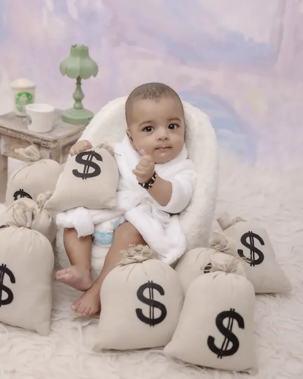 Meet the new boss in town. This creative "Boss Baby" themed shoot is a fun and hilarious way to capture your little one's big personality, complete with a robe and bags of 'money'.