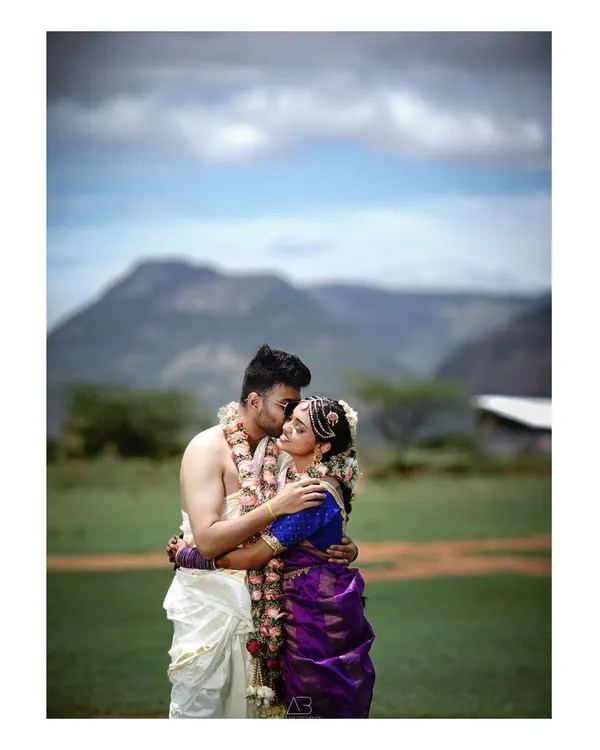 A classic romantic portrait, elevated by the dramatic mountain landscape and cloudy sky. This is about creating that epic, once-in-a-lifetime shot that tells your entire love story.