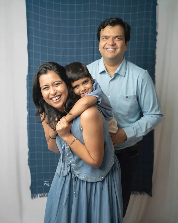 A playful piggyback ride creates the most genuine smiles. This family portrait captures a lighthearted moment of fun and connection between parents and their son during their studio session.