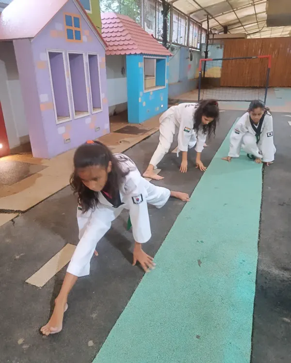 Flexibility is not optional in Taekwondo; it's essential. Here, our students work on their side splits and forward stretches to improve their range of motion for higher, faster kicks.