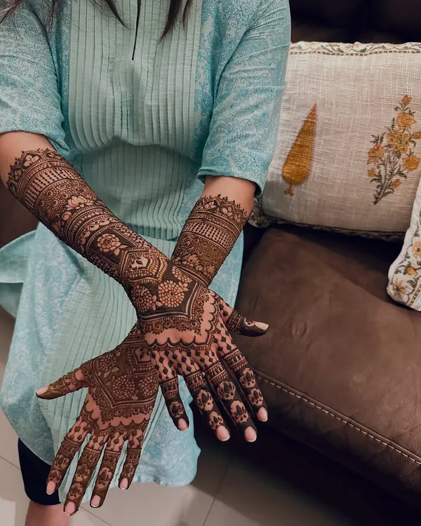 A close-up view of a full-coverage design, showing the crisp lines and detailed floral and geometric patterns that I patiently craft for a traditional look.