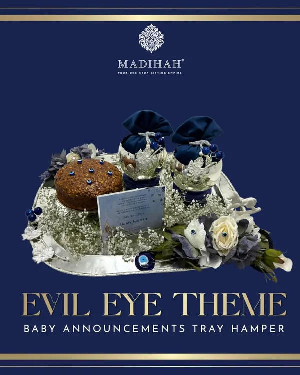 My Evil Eye themed baby announcement tray hamper, designed to offer blessings and protection. This arrangement features a silver tray with navy blue and silver gifts, a personalized card, and the iconic Evil Eye motif.