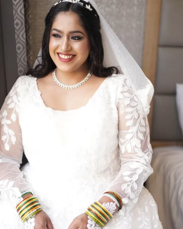 This bride's smile radiates pure joy during her church wedding celebration. I created a soft, timeless look to complement her beautiful white lace gown, focusing on radiant skin and defined eyes that sparkle with happiness.