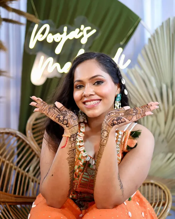 That perfect Mehendi day glow. We kept the makeup fresh and natural to complement her fun, boho-chic outfit and beautiful henna.