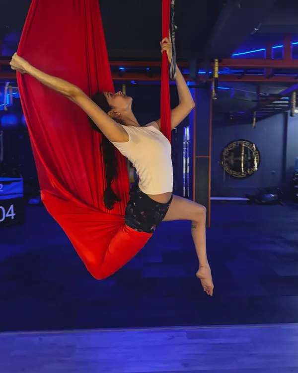 Experience a full-body workout that feels more like flying than exercise. This aerial pose opens up the shoulders and chest while engaging your core for stability.