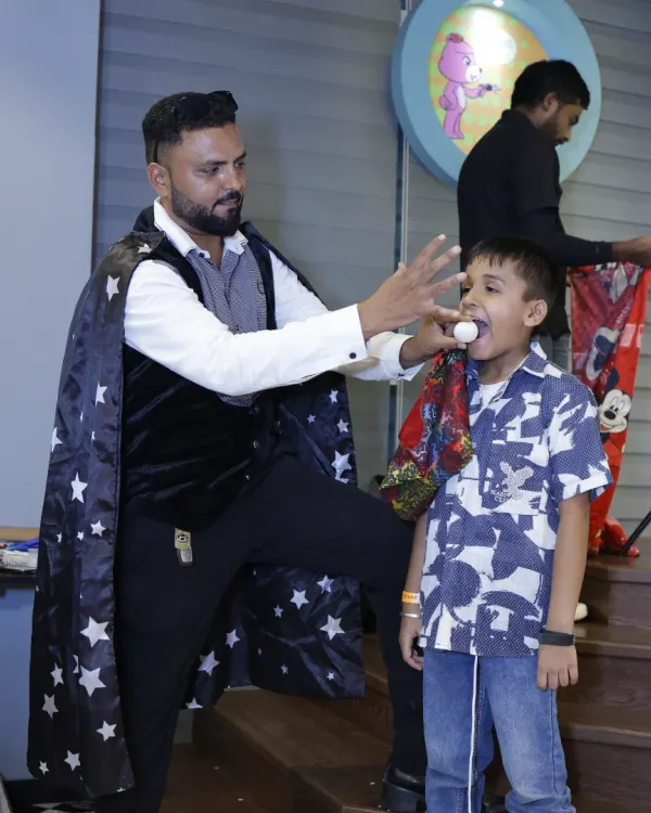 Abracadabra. A magician captivates a young guest during one of our magic show add-ons. This interactive entertainment is always a highlight of the party.