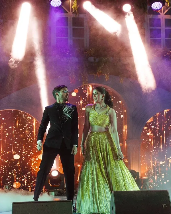 The couple's entry sets the tone for the night. For this Sangeet, we used dramatic stage lighting and a cloud of smoke to create a magical reveal for the shining stars of the evening.
