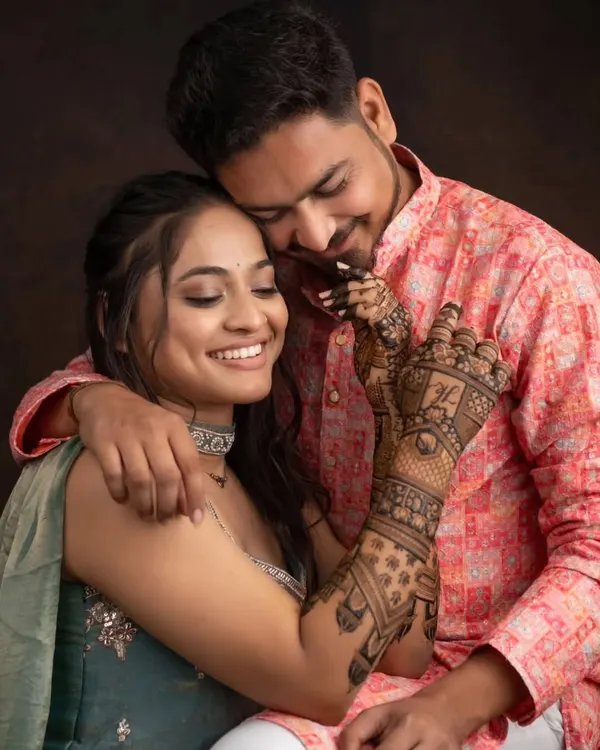 A beautiful moment between the couple, with the bride's intricate mehandi on full display. We love being a part of such special memories.