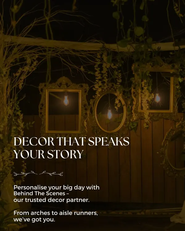 Our trusted decor partner, Behind The Scenes, creates decor that speaks your story. This rustic setup features vintage frames and warm lighting.