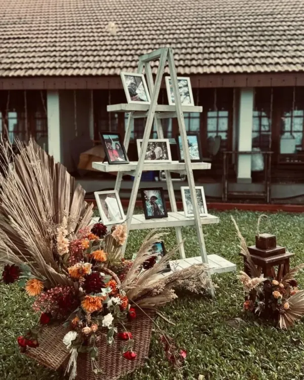 A creative way to display cherished memories. I used a rustic white ladder to create a photo gallery for the couple, surrounded by a beautiful arrangement of dried flowers and pampas grass.