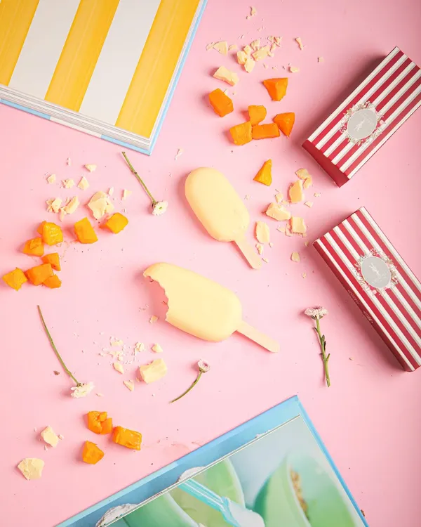 New look, same scoop of joy. Our signature ice cream bars, like this mango and white chocolate one, now come in bold new striped boxes.