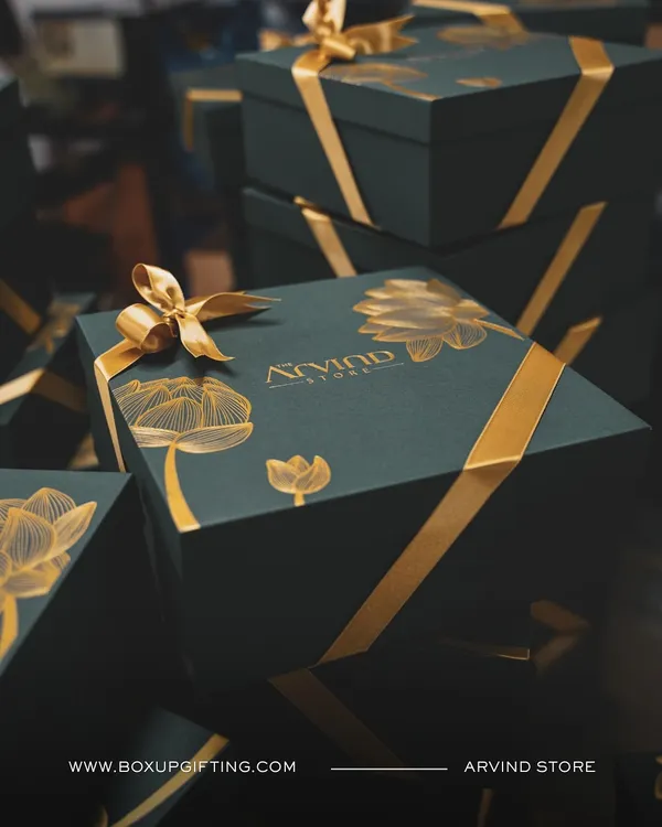 This custom-designed luxury gift box, featuring elegant gold foil on a deep green base, represents the bespoke quality I bring to every wedding and event.