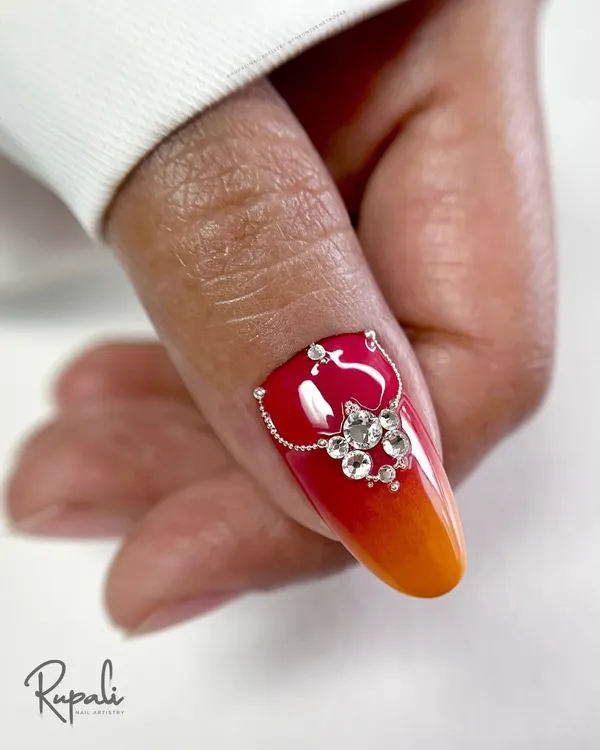 A close-up of the fiery ombre design with Swarovski crystal jewellery on a real nail. This is the kind of high-impact, luxurious look we create in my advanced courses.