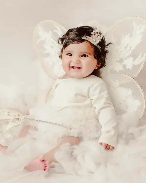 A little angel with delicate fairy wings, sitting on a bed of soft clouds. My themed sessions are designed to create magical, dream-like portraits.