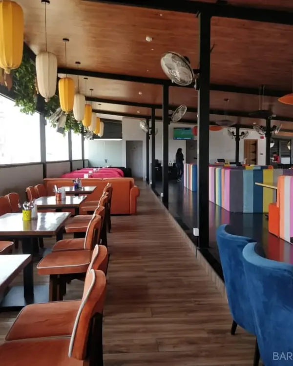 You've probably experienced our work without even knowing it. We designed the vibrant and eclectic interior for Gilly's Resto-Bar, featuring colorful seating and custom furniture.