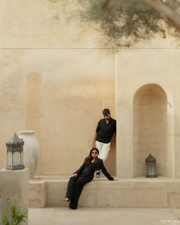 A high-fashion, editorial-style shot of Kinjal and Yash in Dubai, using the clean, sand-colored architecture to create a modern and chic portrait.