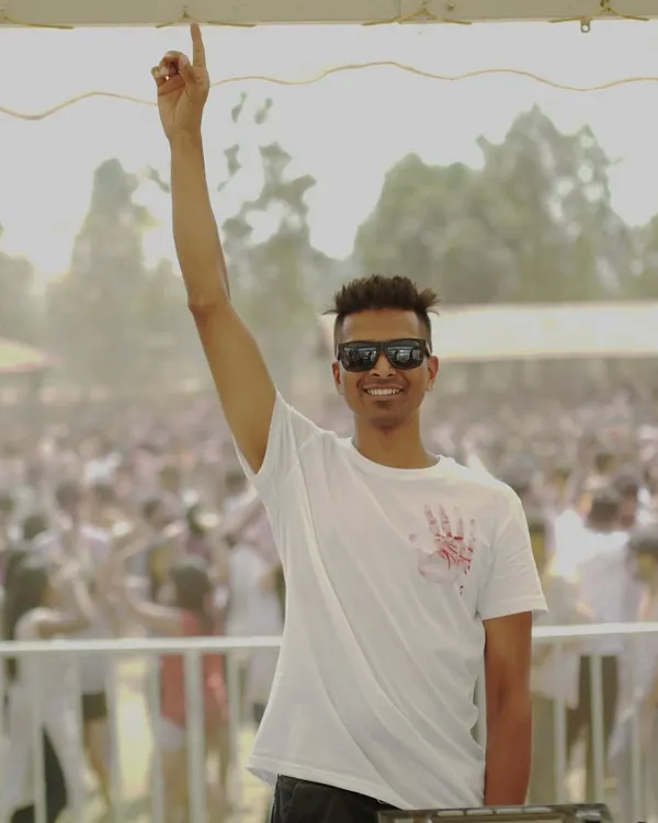 Do me a favor, let's play Holi! A shot of me before the colors hit, with a massive crowd ready for the Desi Holi festival.
