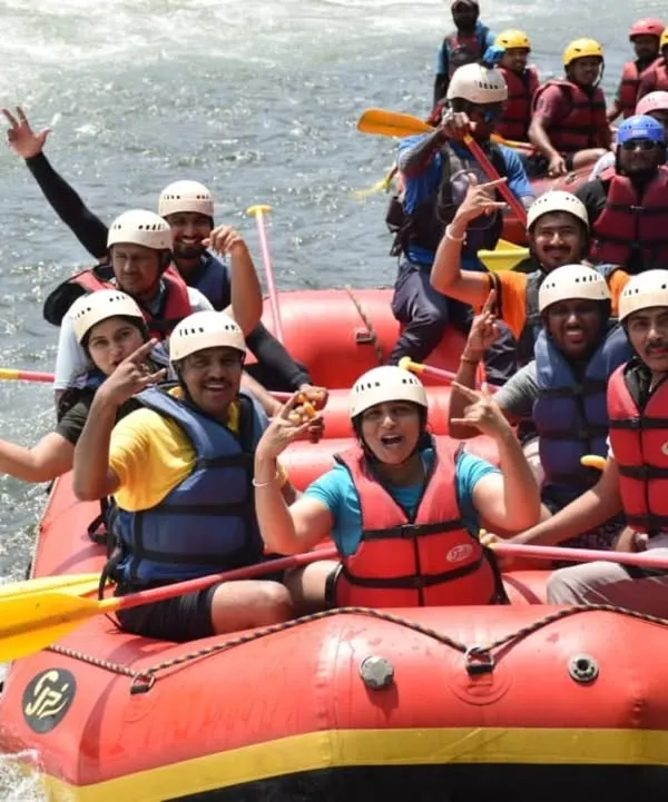 A group of excited trekkers enjoying white water rafting on the Kali river, which is part of our Ulavi Caves adventure package.
