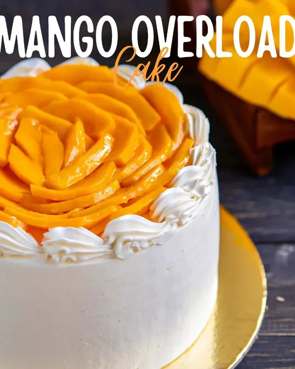 The star of our summer menu, the Mango Overload Cake. It's crafted with layers of light sponge, fresh mango cream, and topped with an intricate rosette of sweet, ripe mango slices.