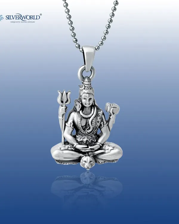 Our Lord Shiva pendant, shown in remarkable detail. This solid silver piece captures Mahadev in a meditative pose, complete with his Trishula and Damaru, as a symbol of divine strength.