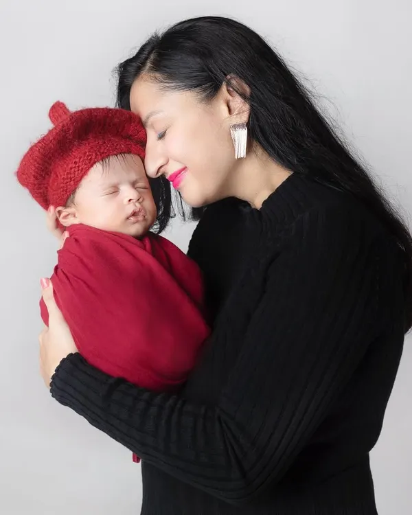 The purest love you will ever know. A mother's gentle touch and loving gaze at her newborn baby says everything.