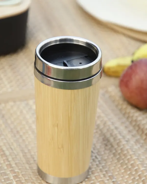 Our bamboo travel mug, shown here in a picnic setting, is perfect for enjoying your favorite beverage anywhere. With a secure lid and stainless steel interior, it's a durable and sustainable choice for your daily coffee or tea.