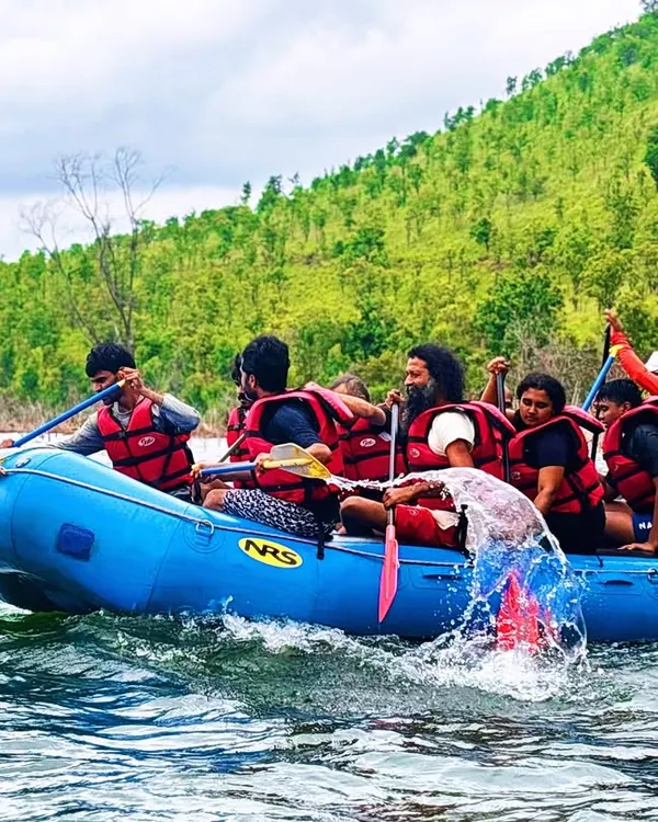 A team paddles in unison during our multi-activity camp at Vani Vilas Sagar. This shot captures the energy and teamwork required for rafting.
