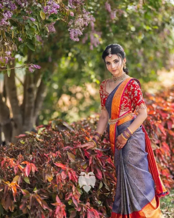 Jahnavi looks absolutely radiant in this custom red velvet blouse for her pre wedding ceremony. The flowing gold zardosi and sequin patterns were designed to create a sense of rhythm and movement, making her look unforgettable.