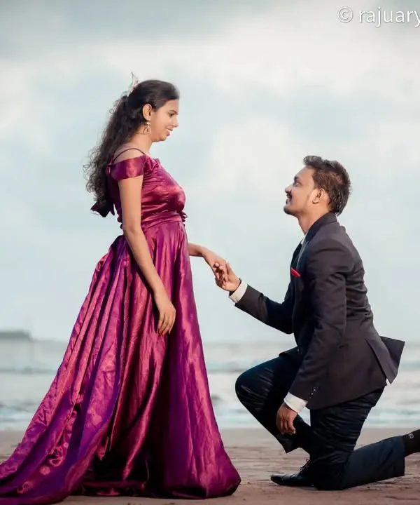 A classic proposal moment captured on the beach. The groom-to-be on one knee against the backdrop of the waves makes for a truly romantic and iconic pre-wedding photograph.