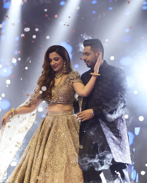 This is the kind of magical moment I live to create. A romantic couple's performance with all the drama of a Bollywood movie, complete with confetti and smoke effects. It's about making you two feel like the only people in the world.
