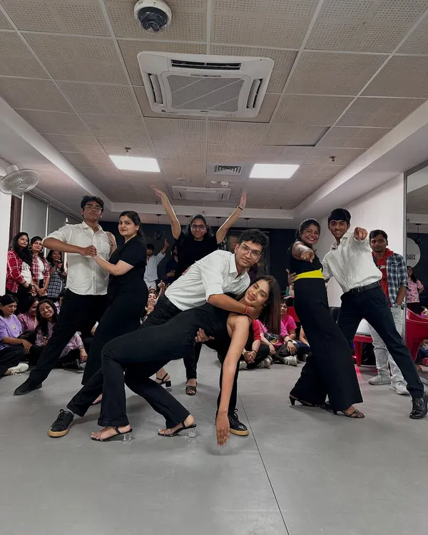 The final pose after nailing a routine. This is the vibe at the end of a successful rehearsal: fun, accomplishment, and great memories with your dance squad.