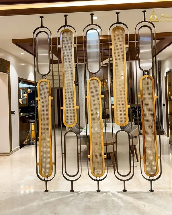 An artistic and functional partition made of metal and woven cane panels. This piece acts as a beautiful screen between the dining and living areas while allowing light to pass through.