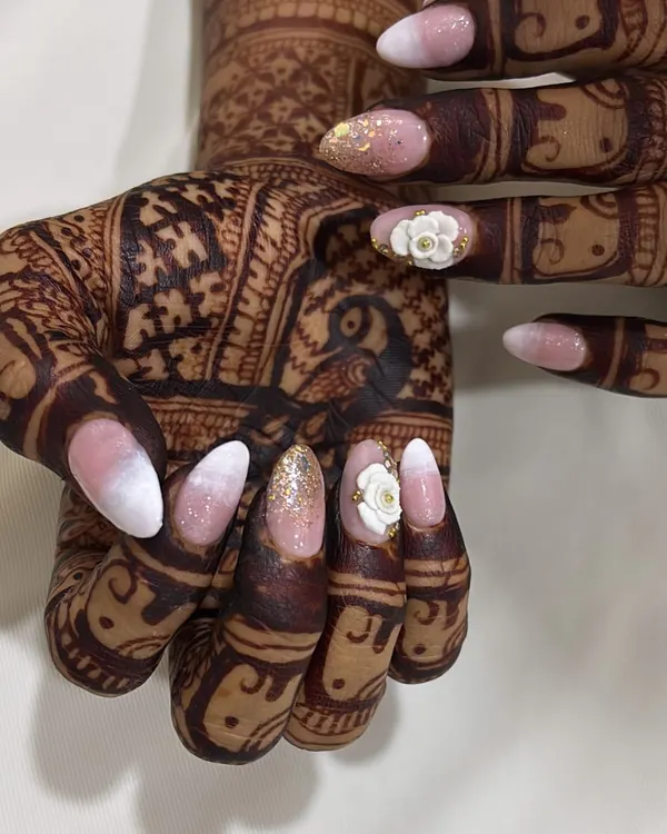 My signature bridal look, featuring a soft ombré, gold glitter, and hand-sculpted 3D flowers. This design is crafted to harmonize beautifully with detailed bridal henna.