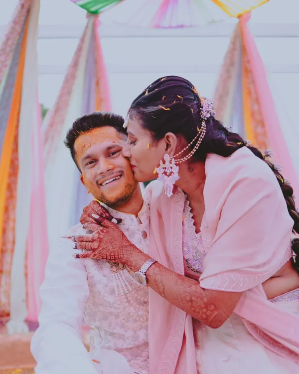 A sweet, candid moment from a Haldi ceremony, with the bride giving the groom a playful kiss on the cheek. These are the real, unposed memories I love to capture.
